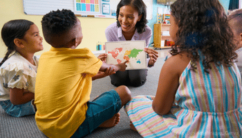 Image of a teacher showing a map to pupils. Image sourced from Canva.
