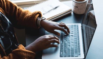 Lady typing on laptop - looking at news